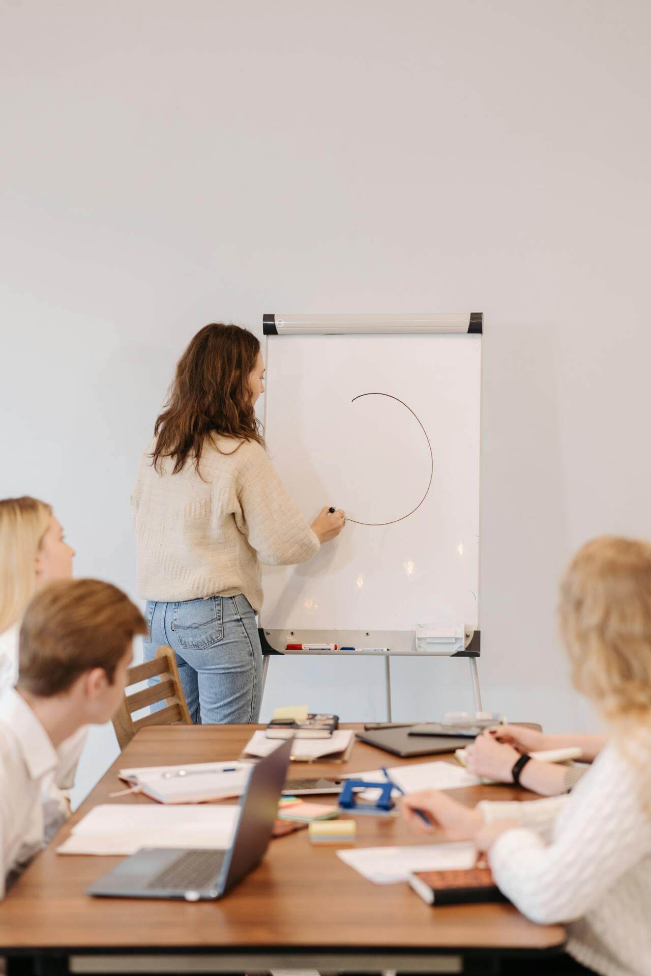 Woman Drawing a Circle on a Board
