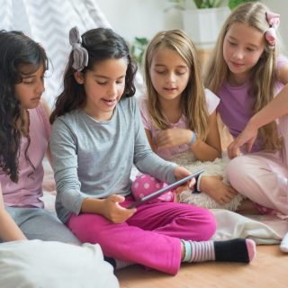 Girls Reading on a Tablet Girls Reading on a Tablet